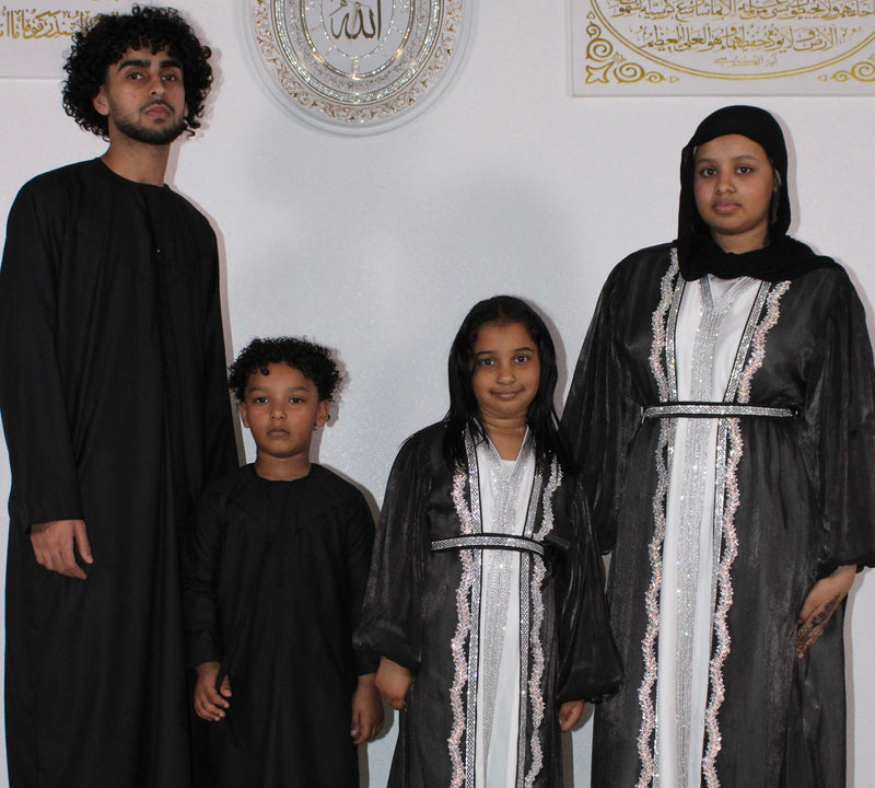Family in matching black abayas and thobes