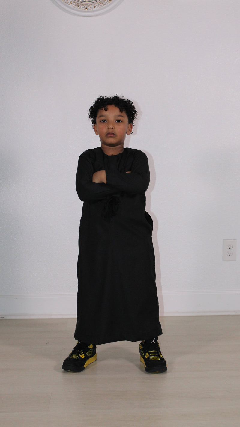 Boy in a black kids thobe